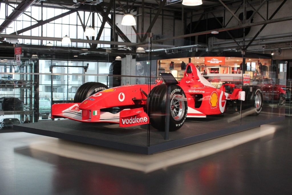 red ferrari f 1 on gray pavement