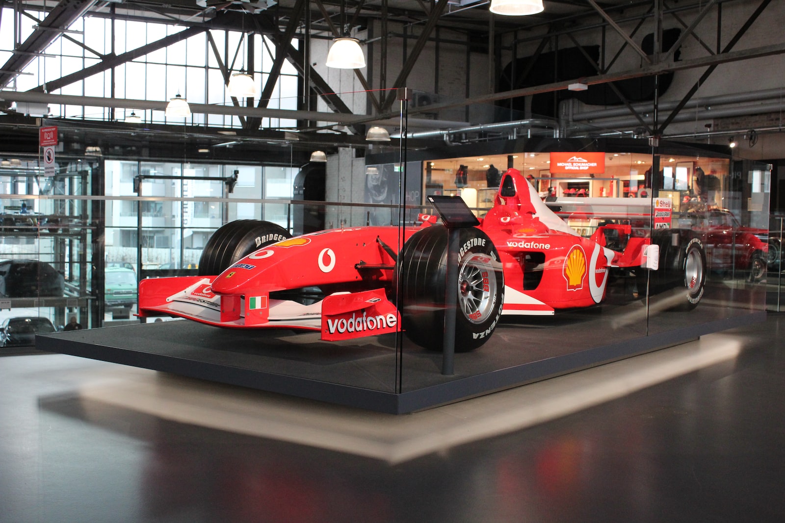 red ferrari f 1 on gray pavement