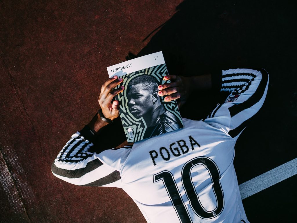 Paul Pogba manque France absent coupe du monde Qatarhite and black adidas jersey shirt holding black and white textile