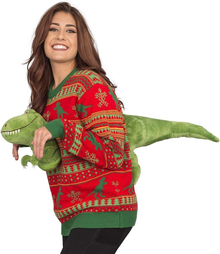 Un pull de Noël avec une peluche T-Rex certainement le meilleur pull de tous les temps