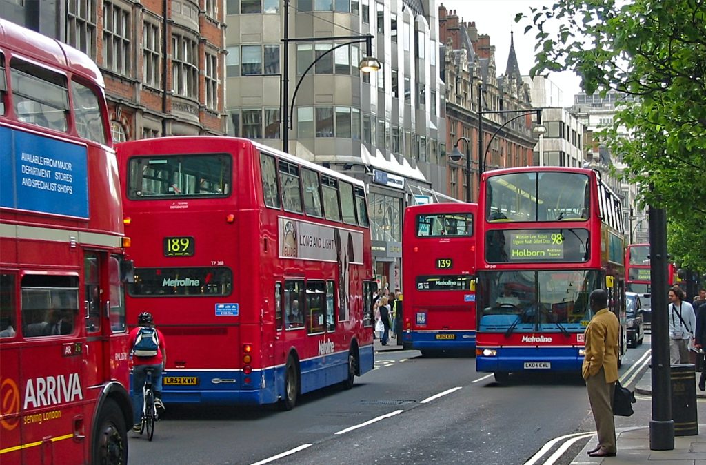 red double decker bus on road during daytime