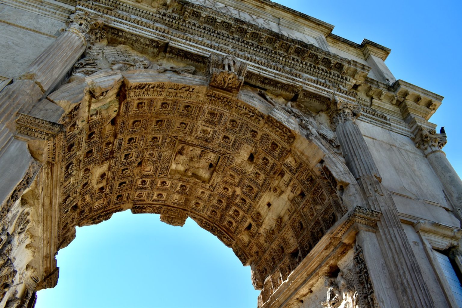 L’Arc de Titus – Une merveille architecturale de Rome antique low angle photography of arc de triomphe