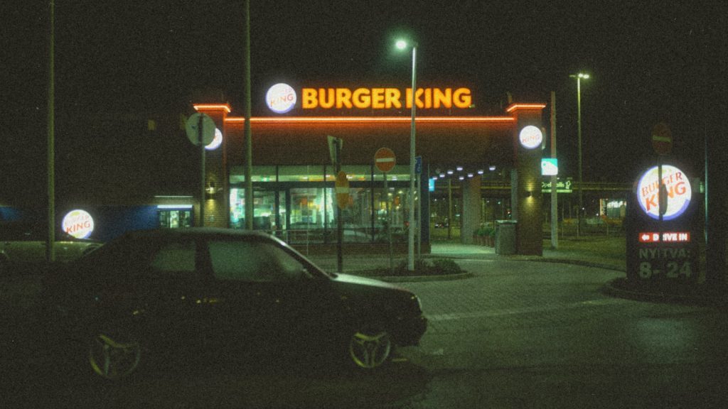 a car parked in front of a burger king restaurant