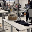 tesla optimus shirt folding laundry video 1000x600 - plare.