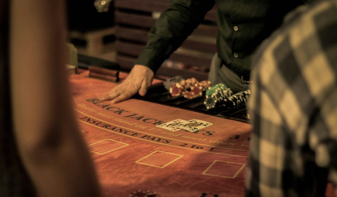 man in green dress shirt sitting on chair